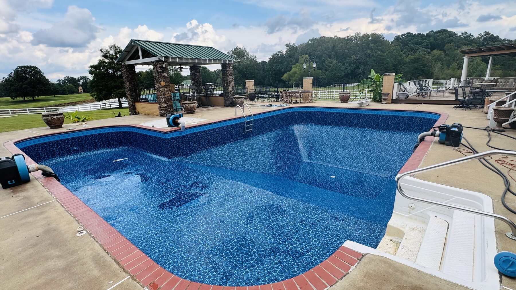 Same pool with a new blue liner as it begins to fill