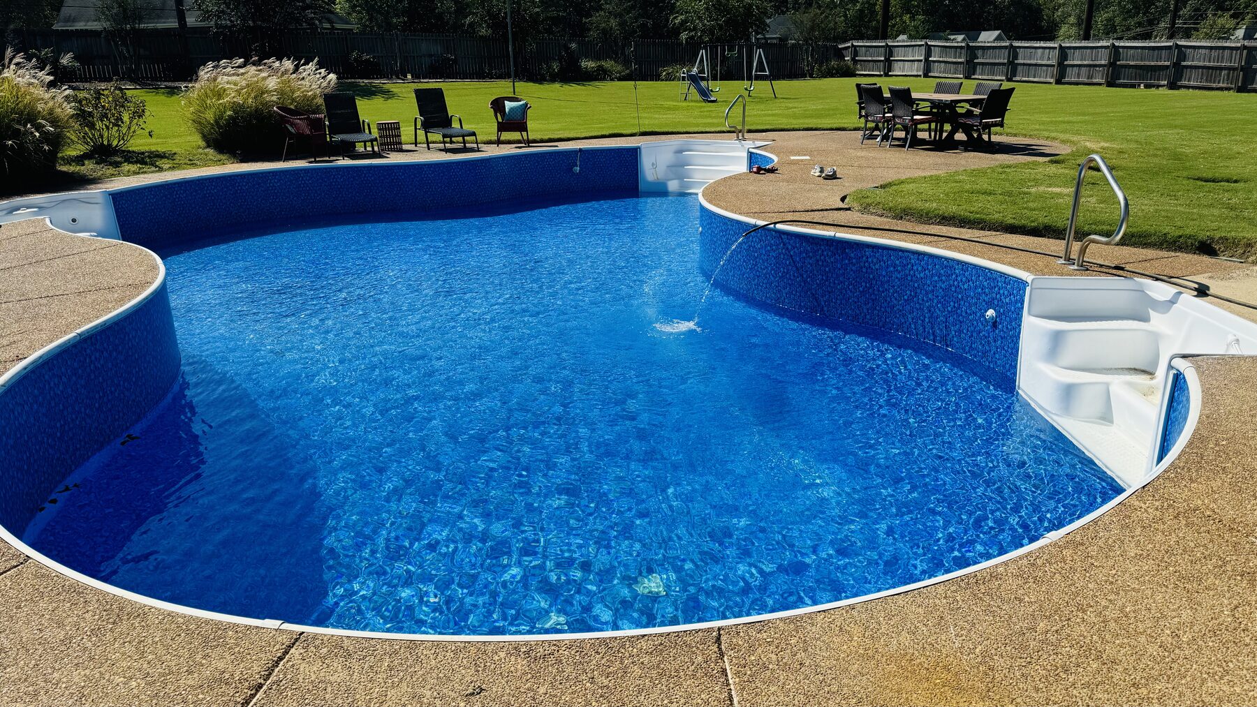 Same freeform pool filled with clear blue water